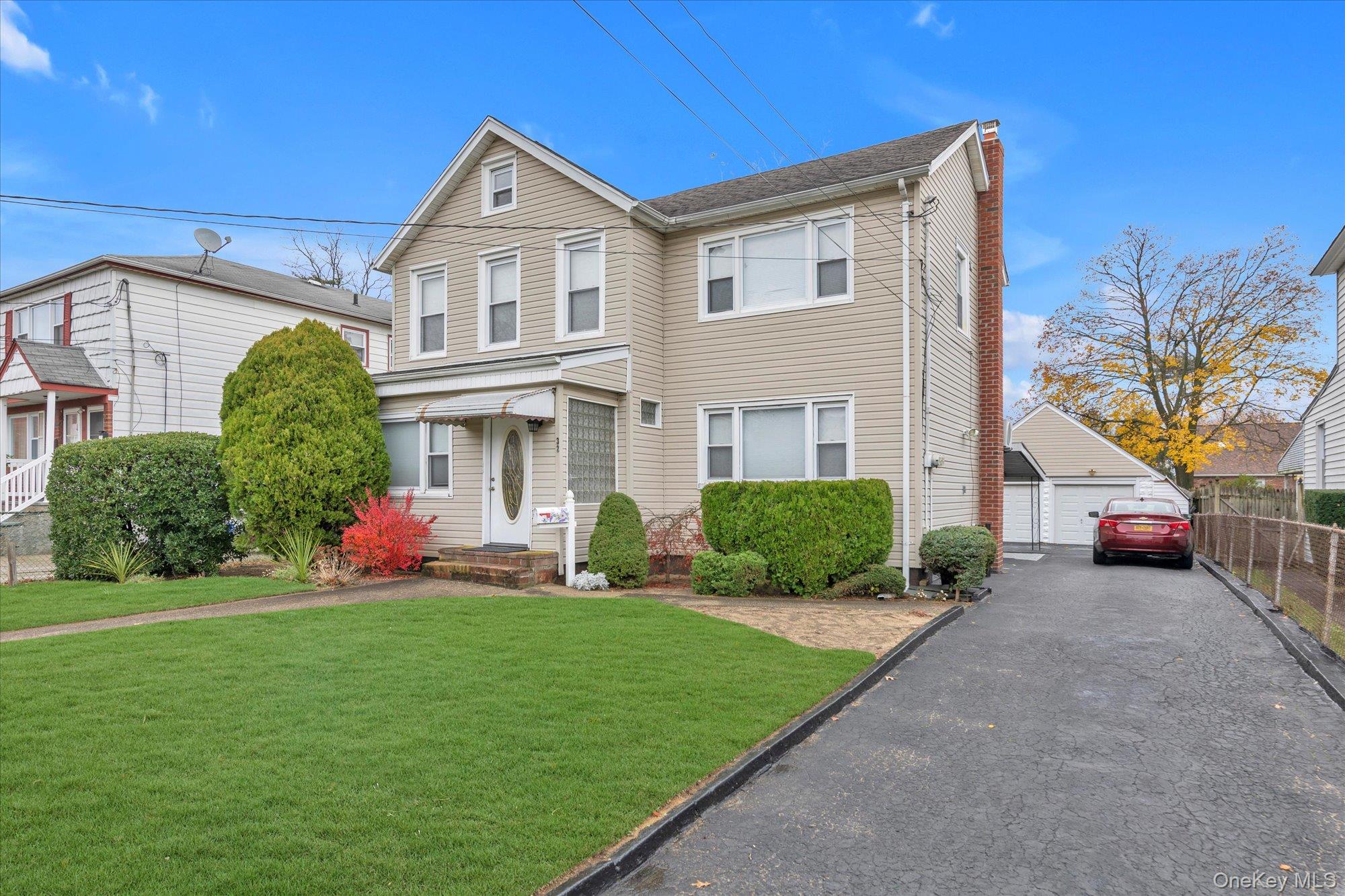 32 5th Street Valley Stream, NY 11581 - Photo 19 of 23 a front view of a house with a yard and potted plants