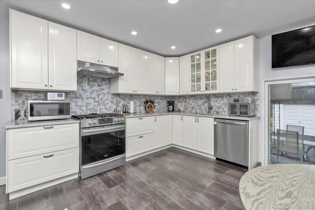 a kitchen with a refrigerator stove and microwave