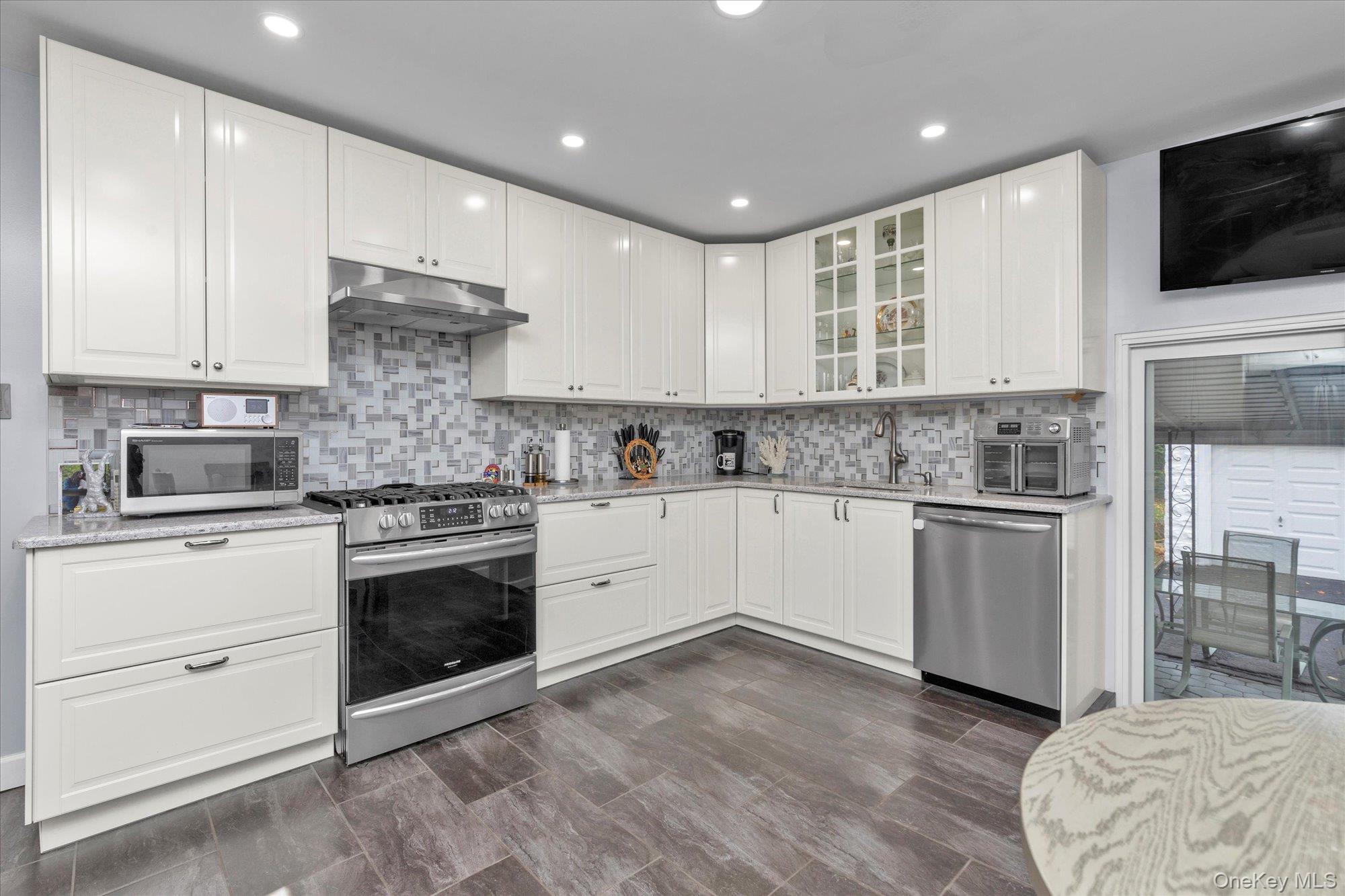 32 5th Street Valley Stream, NY 11581 - Photo 5 of 23 a kitchen with a refrigerator stove and microwave