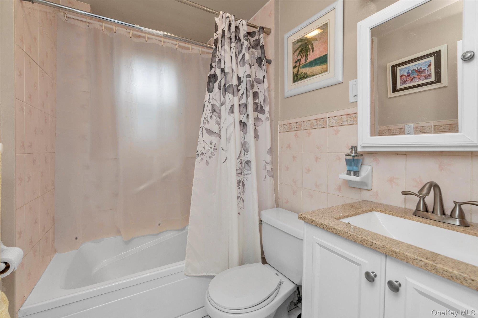 32 5th Street Valley Stream, NY 11581 - Photo 8 of 23 a bathroom with a sink a toilet and a bathtub