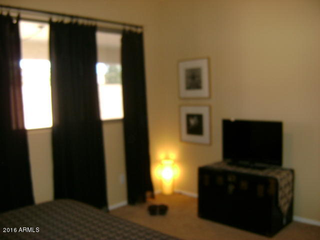 11174 West Berkeley Road Avondale, AZ 85392 - Photo 18 of 41 a living room with a flat screen tv and a fireplace