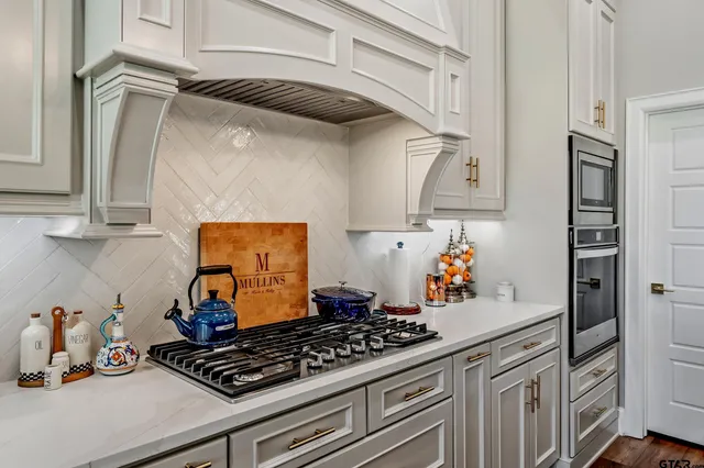 a kitchen with a stove and cabinets