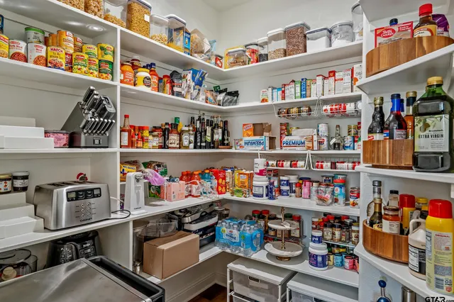 a room with lots of books and a wooden floor
