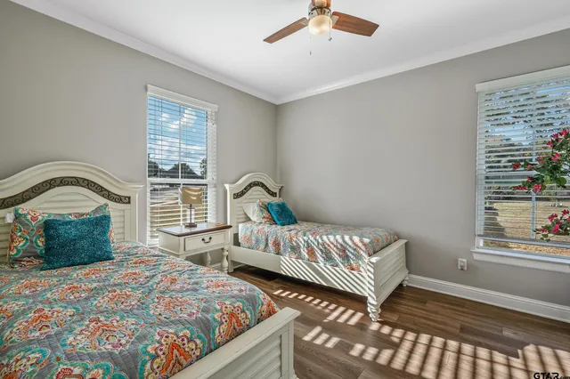 a bedroom with two beds and a window