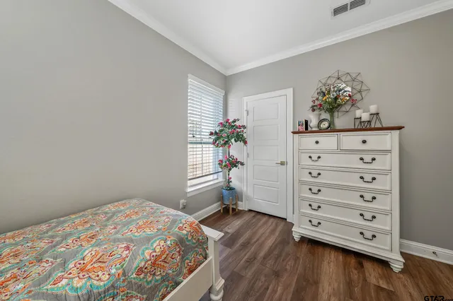 a bedroom with a bed and a dresser