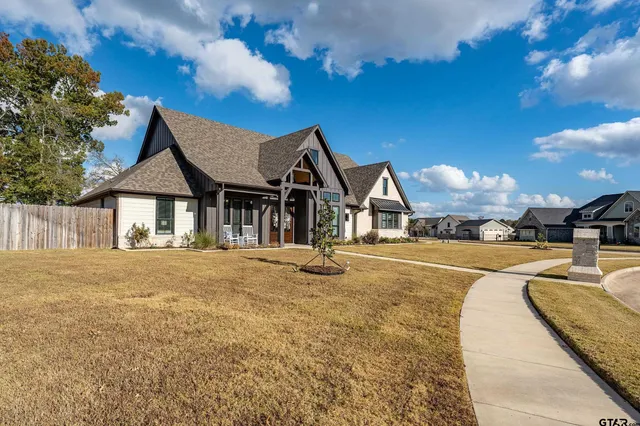 a view of a house with swimming pool and sitting area