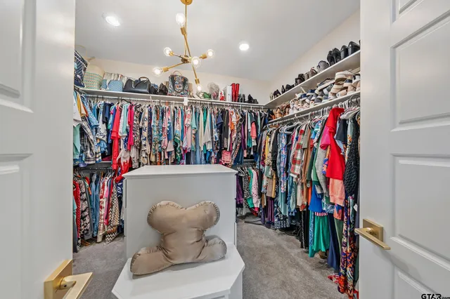 a view of walk in closet with clothes
