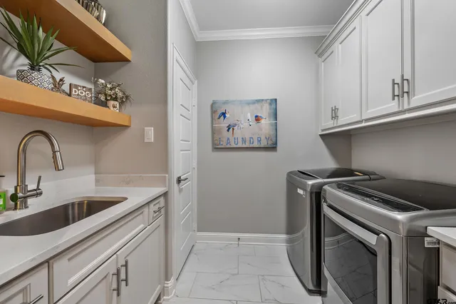 a kitchen with granite countertop a sink a stove and cabinets
