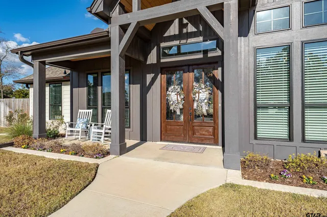 a bedroom with a bed and windows