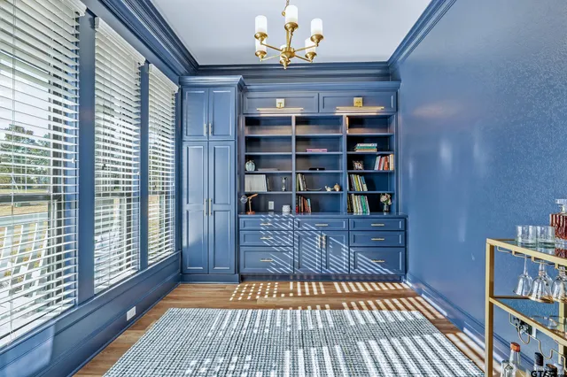 a room with bookshelf and a window