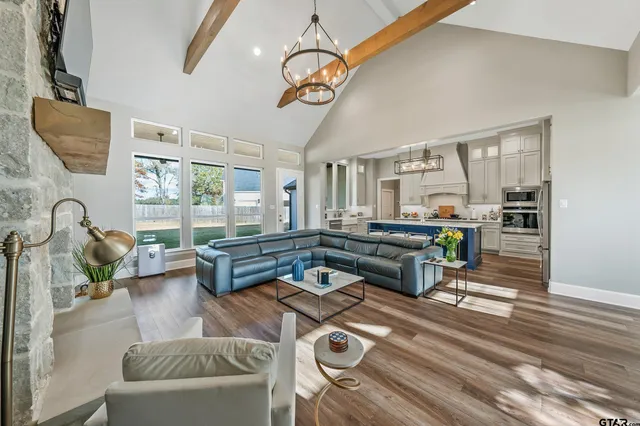 a living room with furniture a rug and white walls
