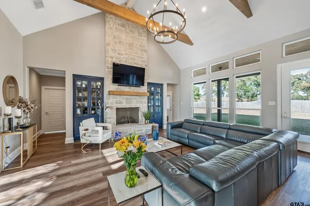 a living room with fireplace furniture and a flat screen tv