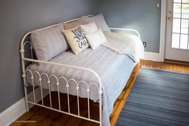 a bed sitting in a bedroom next to a window
