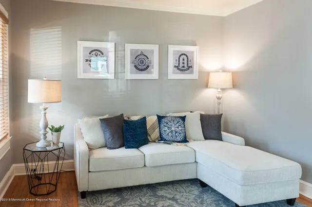 a living room with furniture and painting on the wall