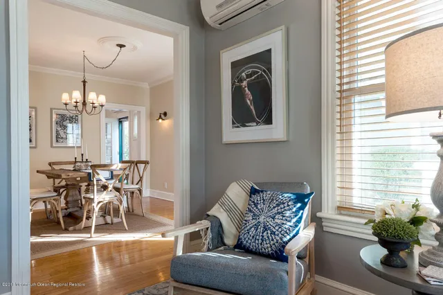 a living room with furniture and a chandelier