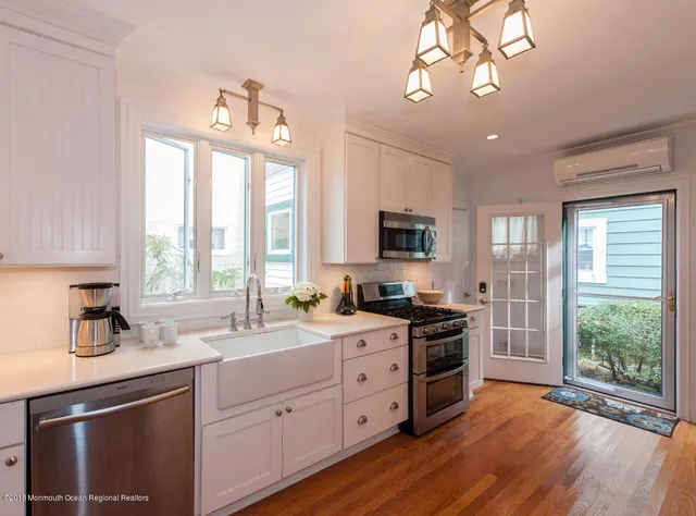a kitchen with a stove a sink and a refrigerator
