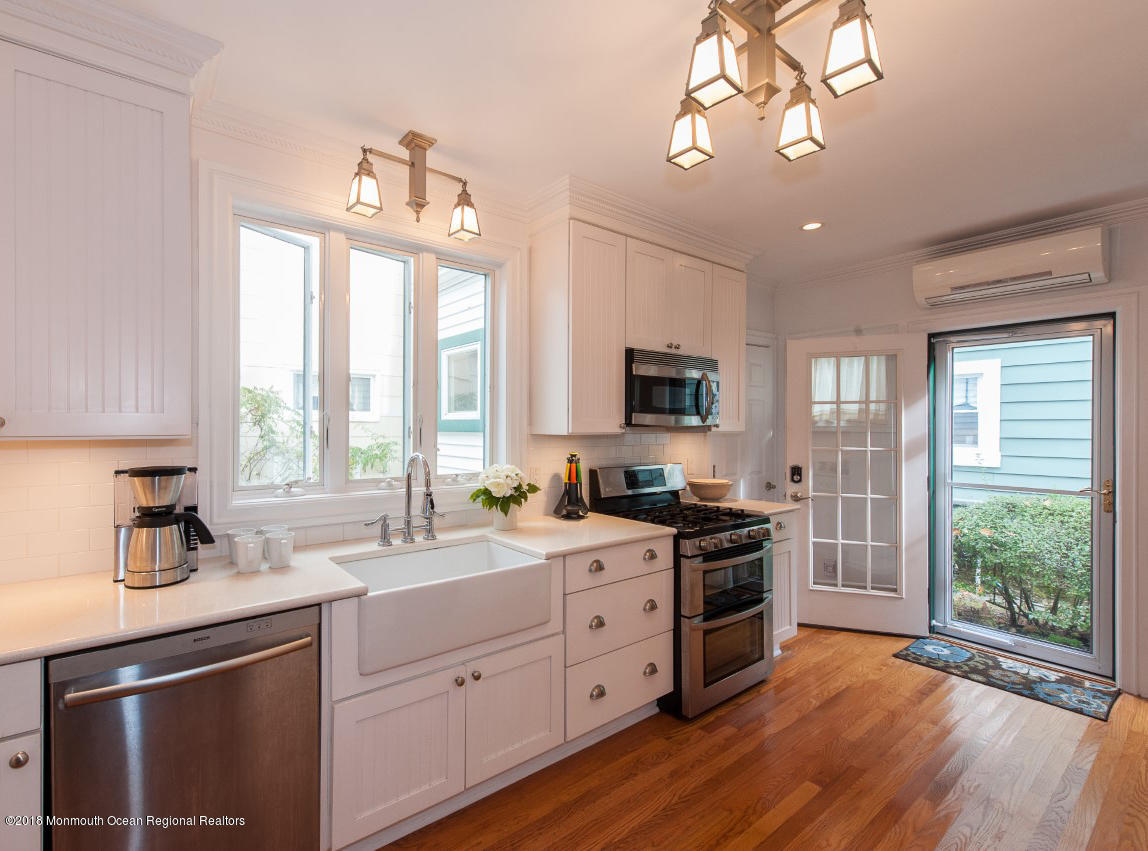 21 Surf Avenue Ocean Grove, NJ 07756 - Photo 8 of 20 a kitchen with a stove a sink and a refrigerator