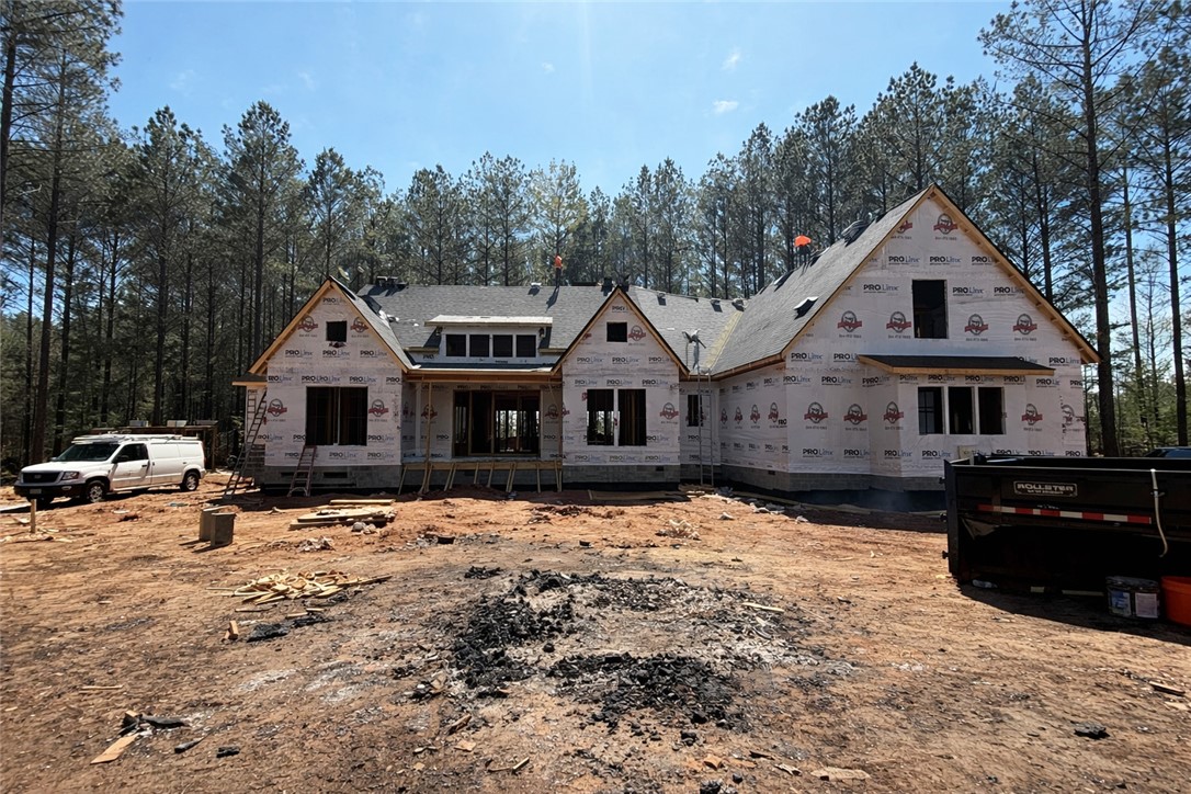 204 Rogers Road Pendleton, SC 29670 - Photo 3 of 12 This newly framed home awaits its finishing touches, nestled among towering trees.