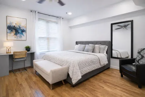 a bedroom with a large bed and a couch