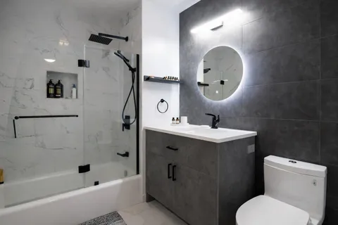 a bathroom with a toilet sink and mirror