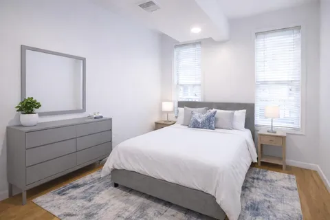 a bedroom with a bed and a dresser