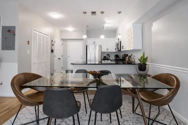 a kitchen with a dining table chairs and a stove