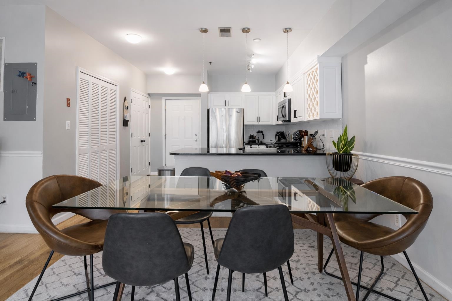 901 Madison Street, Unit 5F Hoboken, NJ 07030 - Photo 7 of 20 a kitchen with a dining table chairs and a stove