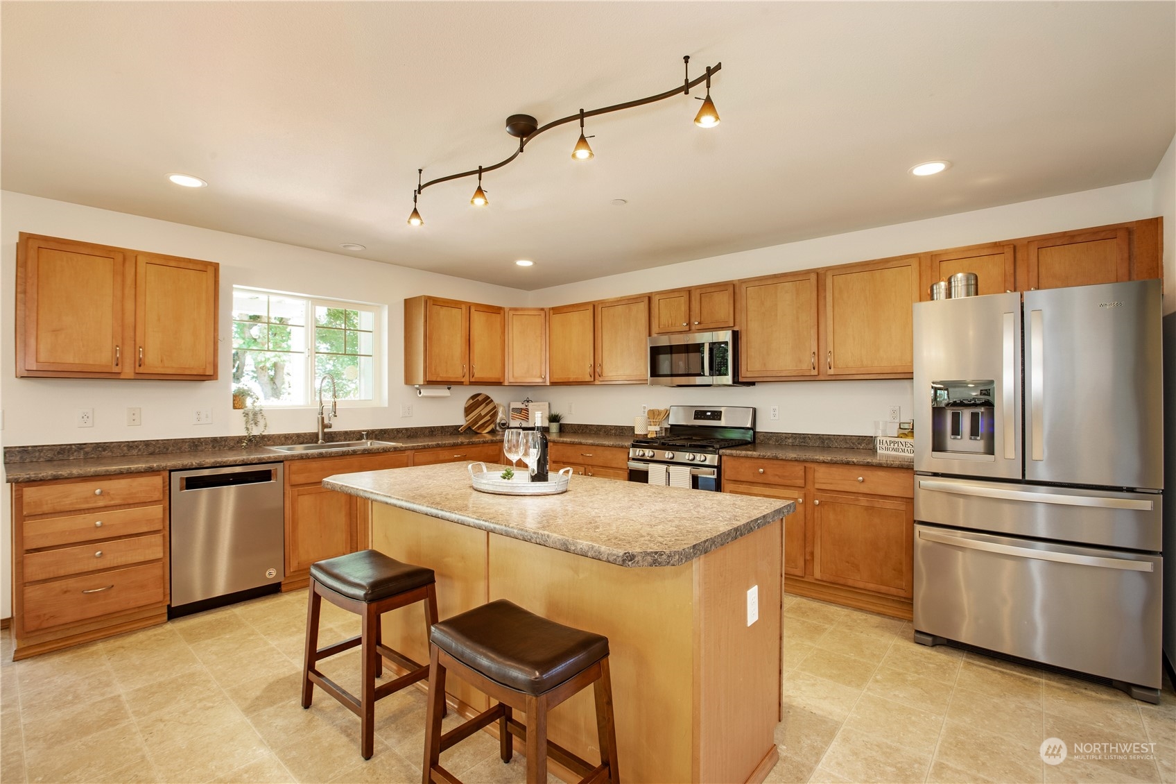 3139 Walker Road DuPont, WA 98327 - Photo 12 of 40 a kitchen with stainless steel appliances granite countertop a stove refrigerator sink and cabinets