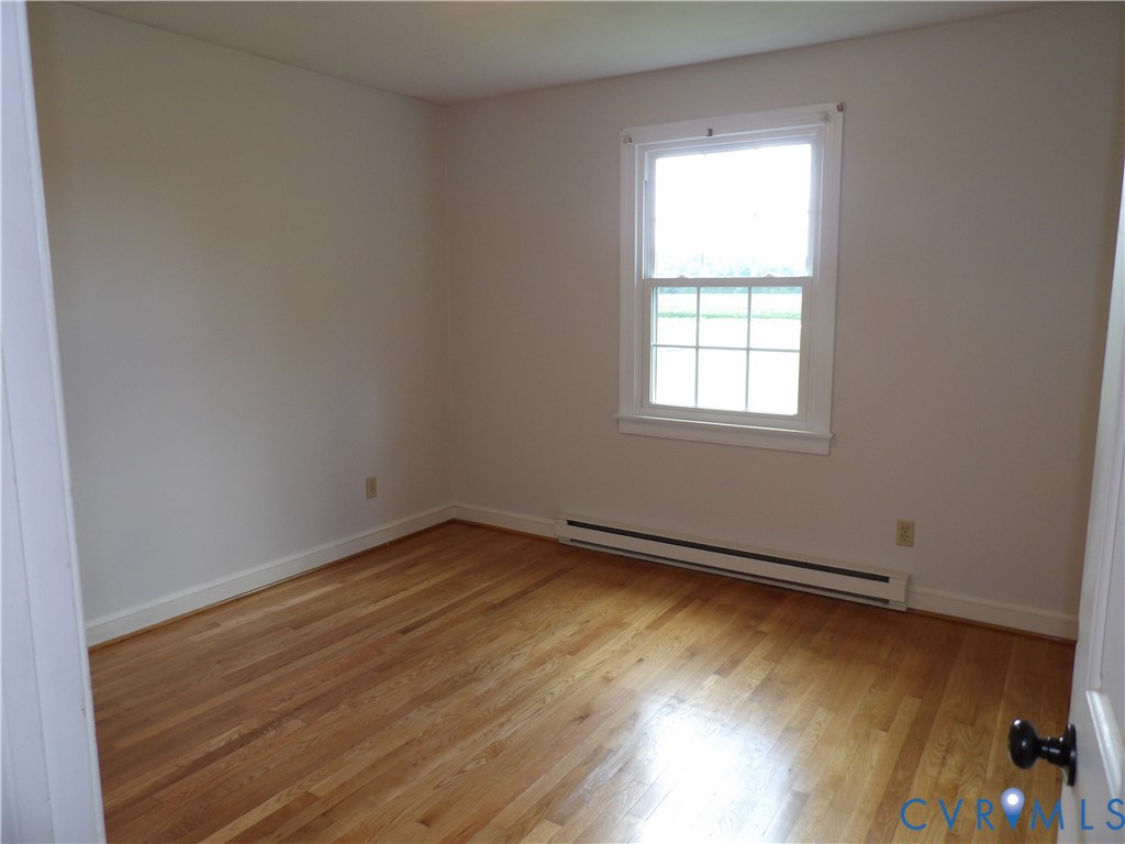 3813 Johnson Road Petersburg, VA 23805 - Photo 38 of 51 Hardwood flooring throughout, white trim, and a wi