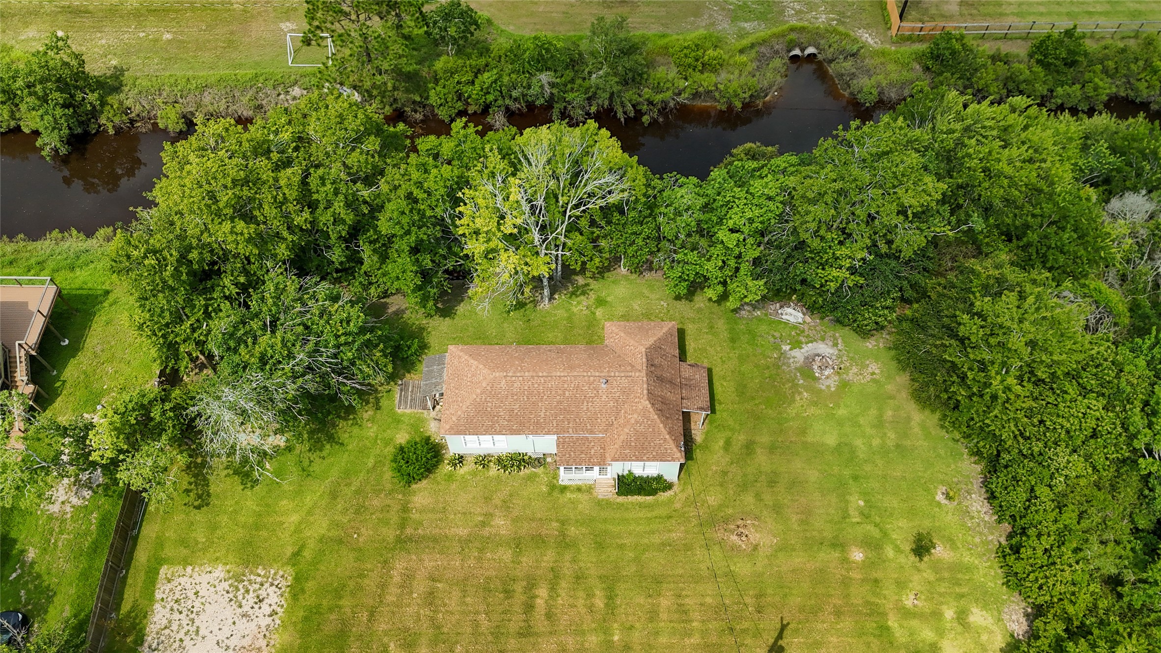12903 Sandpiper Road Angleton, TX 77515 - Photo 2 of 19 4 lots on 0.66 acres with nearly 230 feet of canal frontage. A rare combination of space, privacy and water access that is hard to find under $200K.