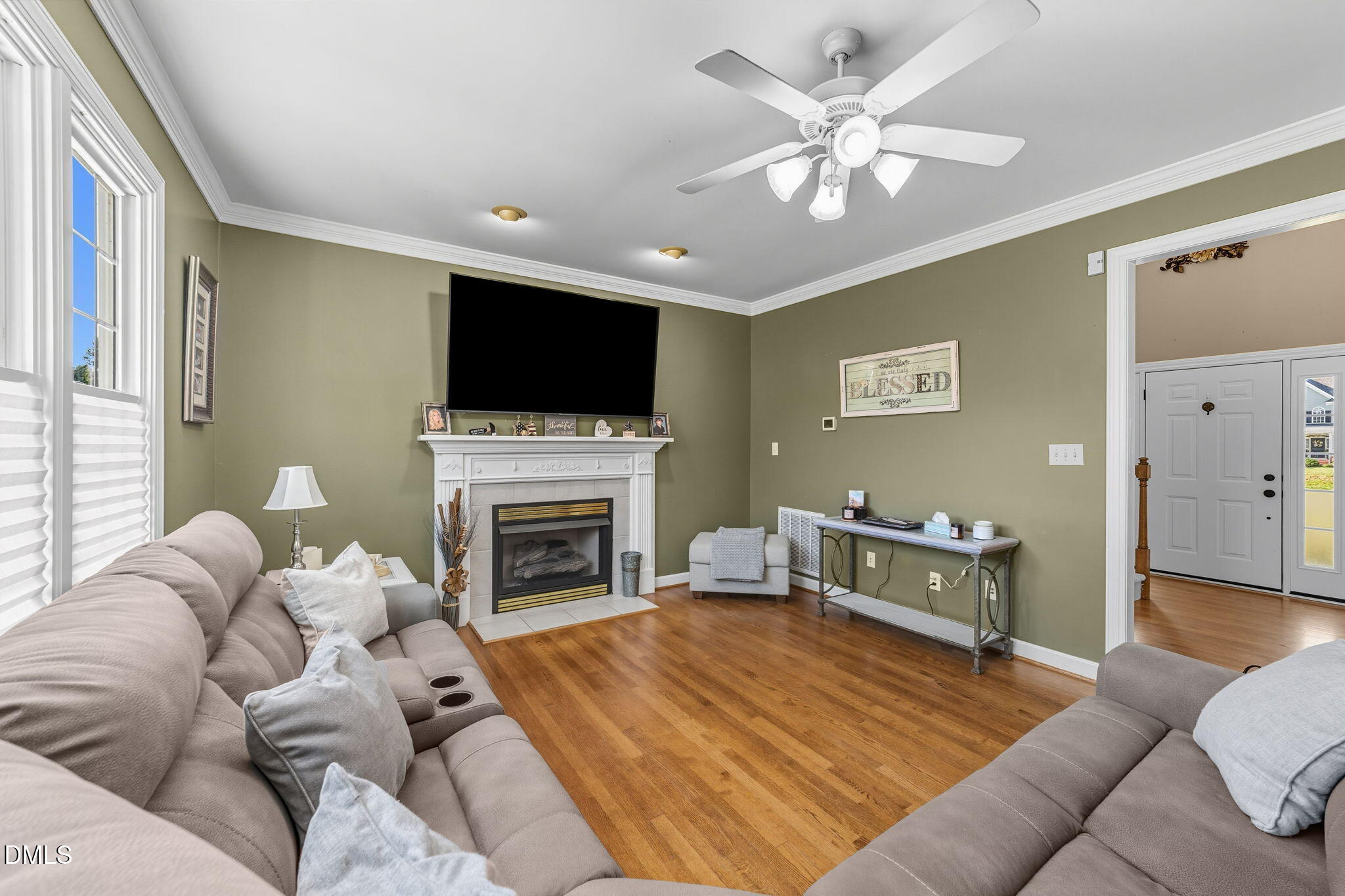 1617 Kendall Hill Road Willow Spring, NC 27592 - Photo 28 of 58 a living room with furniture a fireplace and a flat screen tv