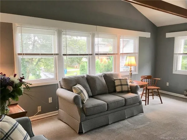 a living room with furniture and a large window