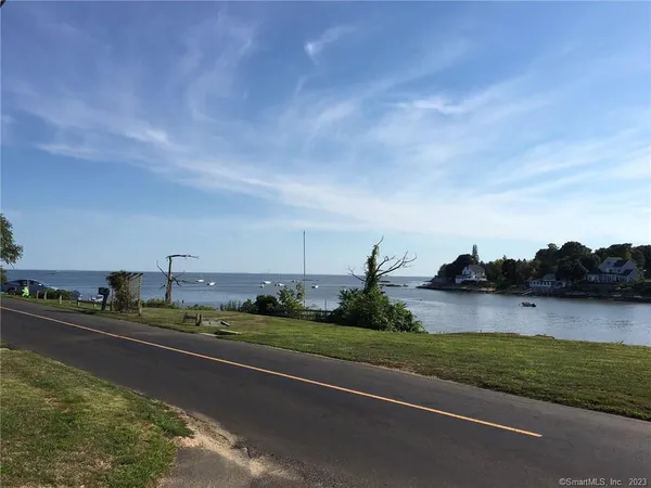 a view of a lake with green yard