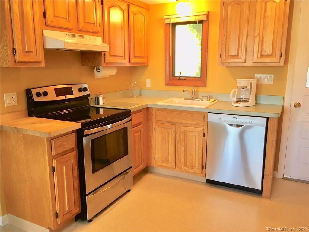 87 Decatur Avenue Guilford, CT 06437 - Photo 21 of 29 a kitchen with stainless steel appliances granite countertop a sink a stove and a microwave