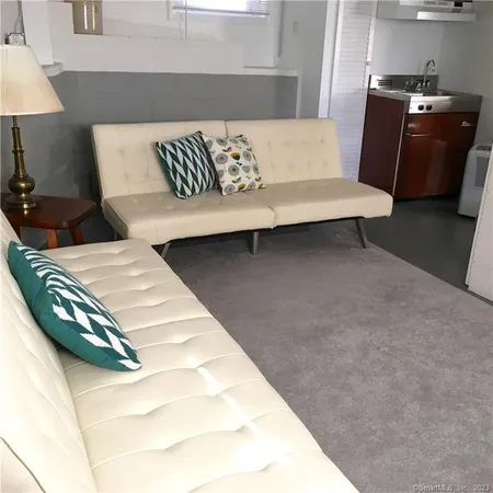 a living room with a couch and a lamp