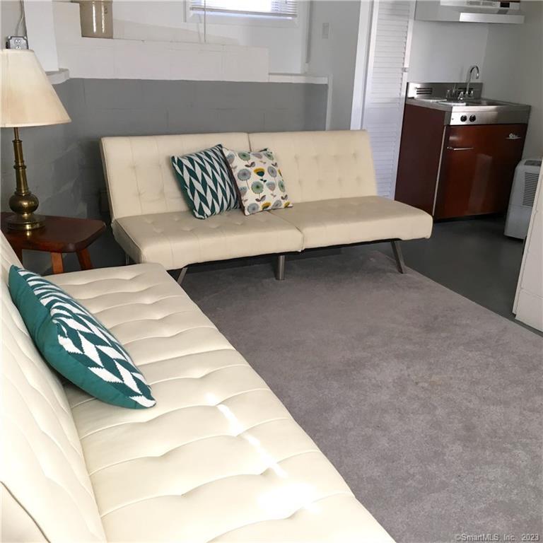 87 Decatur Avenue Guilford, CT 06437 - Photo 24 of 29 a living room with a couch and a lamp