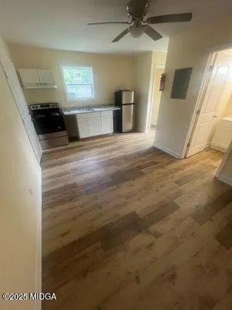 a view of a kitchen cabinets and a wooden floor