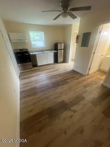 a view of a kitchen cabinets and a wooden floor