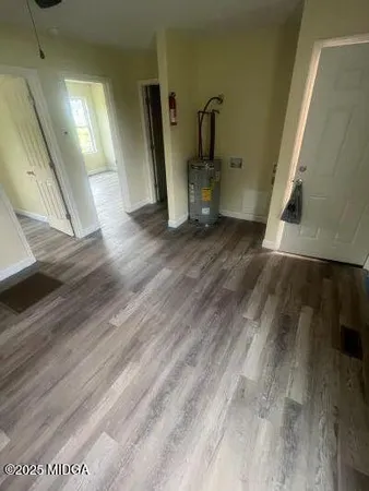 a view of empty room with wooden floor