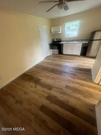 a kitchen with stainless steel appliances a refrigerator and microwave