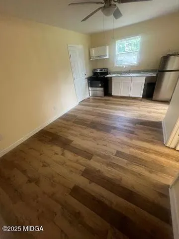 a kitchen with stainless steel appliances a refrigerator and microwave