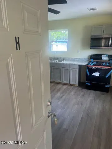 a kitchen with a refrigerator and a sink