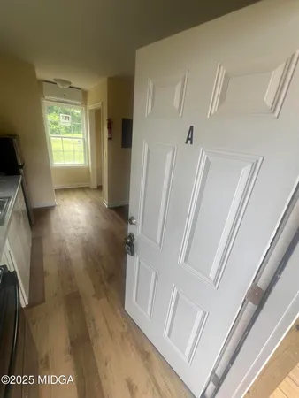 a view of entryway with wooden floor and a rug