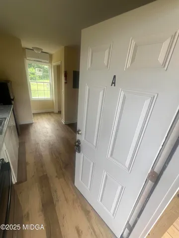 a view of entryway with wooden floor and a rug