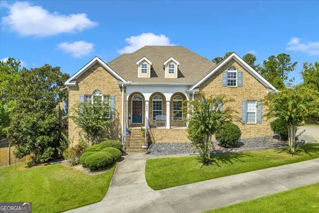a front view of a house with a garden