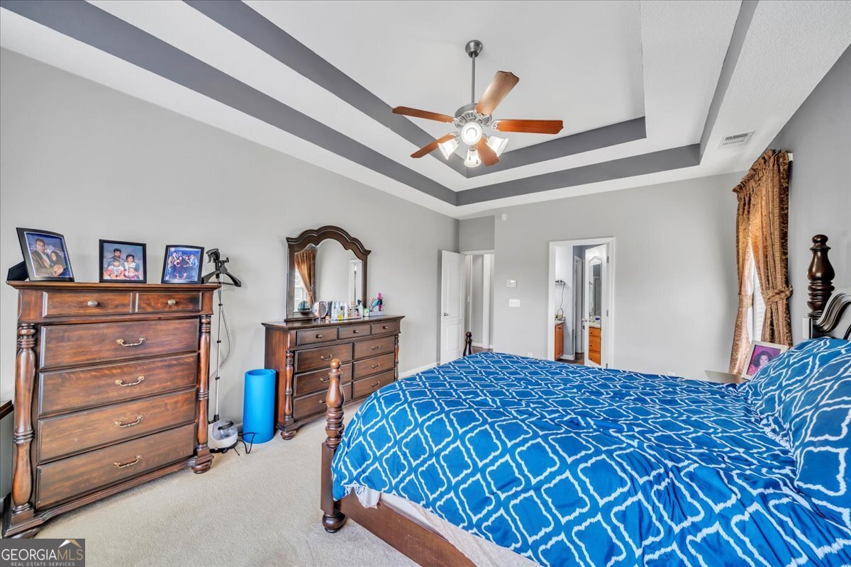 605 Dodds Walk Macon, GA 31220 - Photo 17 of 68 a bedroom with a bed and a chandelier