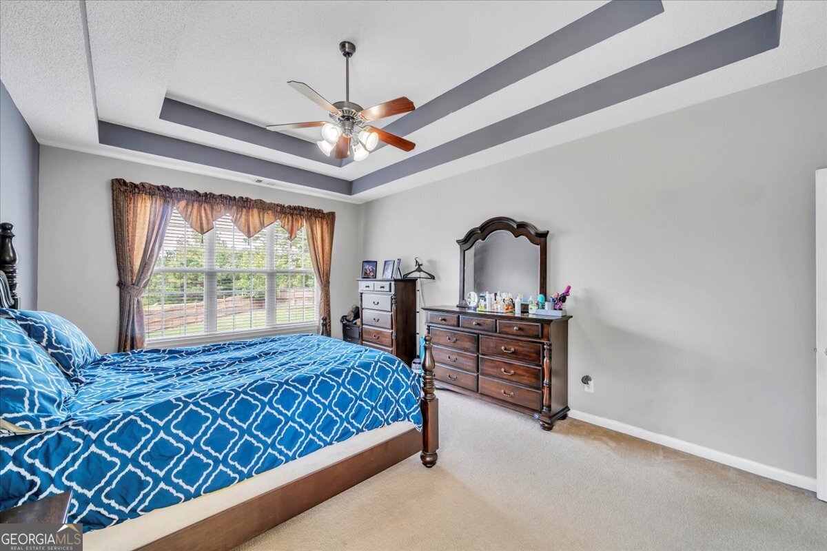 605 Dodds Walk Macon, GA 31220 - Photo 18 of 68 a bedroom with a bed and a chandelier