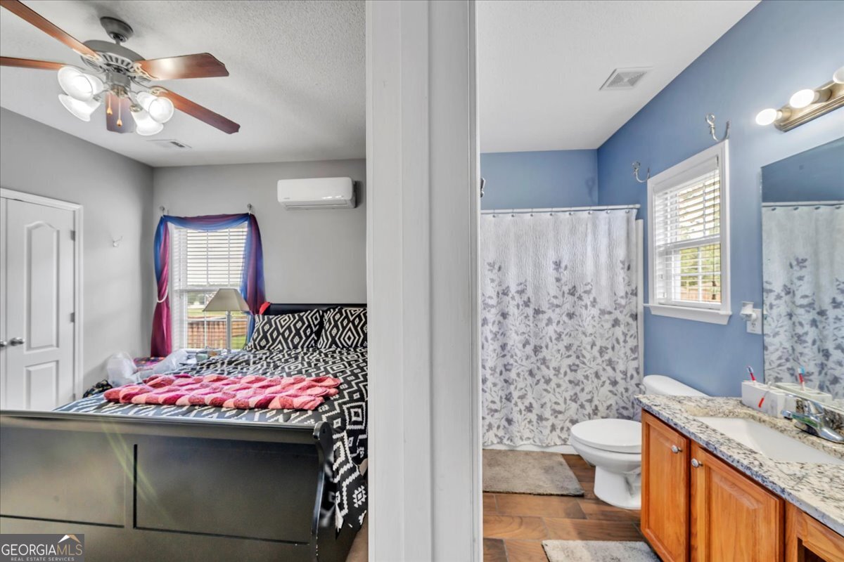 605 Dodds Walk Macon, GA 31220 - Photo 22 of 68 a bathroom with a sink vanity granite toilet and a shower