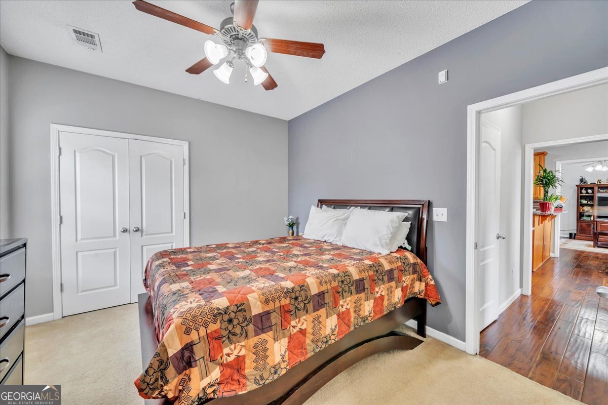 605 Dodds Walk Macon, GA 31220 - Photo 24 of 68 a bedroom with a bed and a chandelier