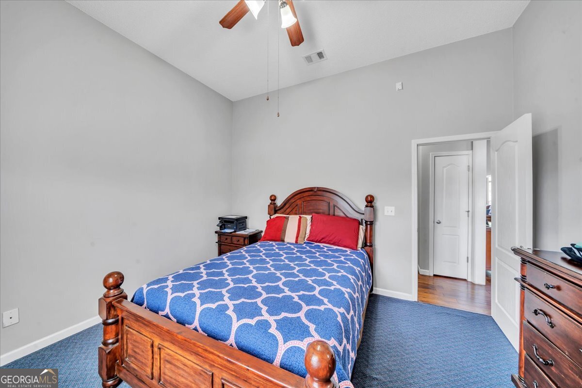605 Dodds Walk Macon, GA 31220 - Photo 27 of 68 a bedroom with a bed and wooden floor
